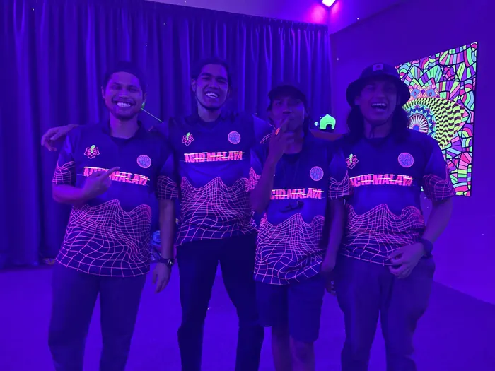 The crew in matching jerseys under UV light