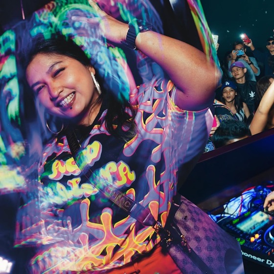 Woman laughing in a colourful printed shirt